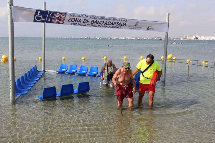 lifeguard helping a person on the beach