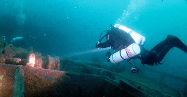 Person diving near a wreck