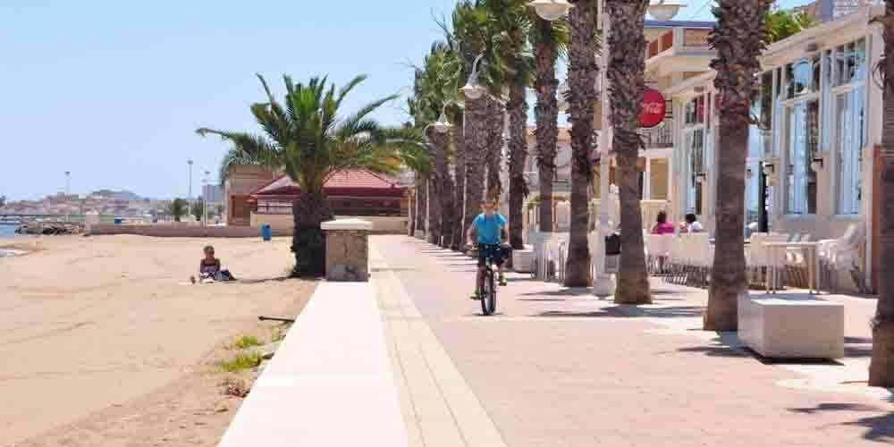 A child on a bike across Los Nietos Beach