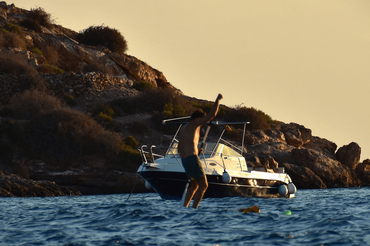 image of a person swimming after a boat ride