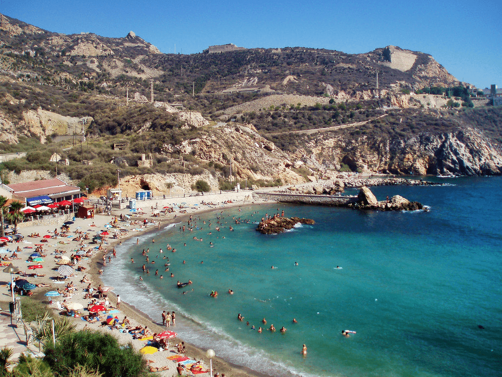 image of Cala Cortina with multiple tourists in the sea