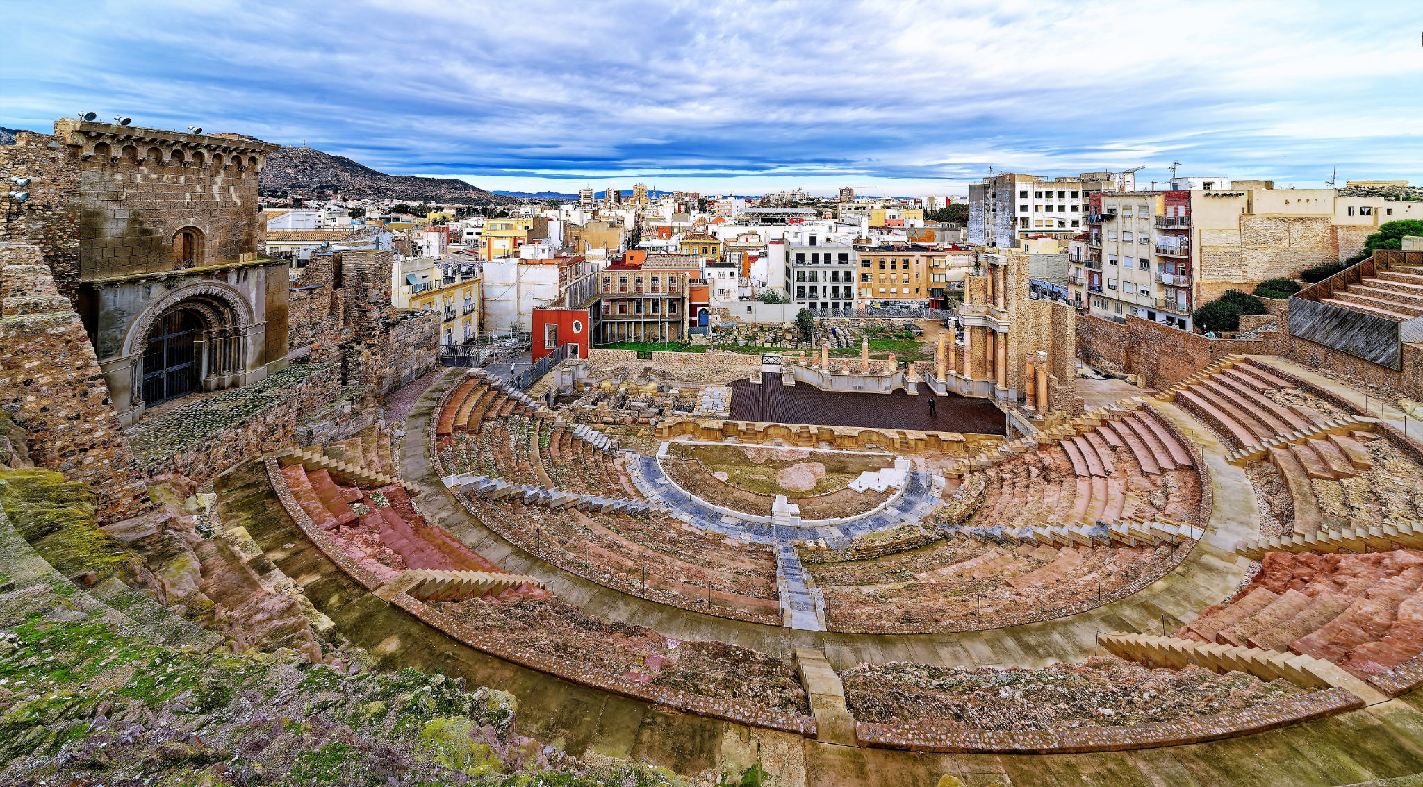 image of the ruins of the roman museum along with the city on the background