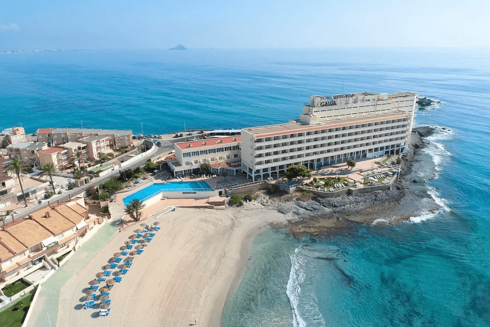 image showing the beach along with Hotel Galúa in the middle