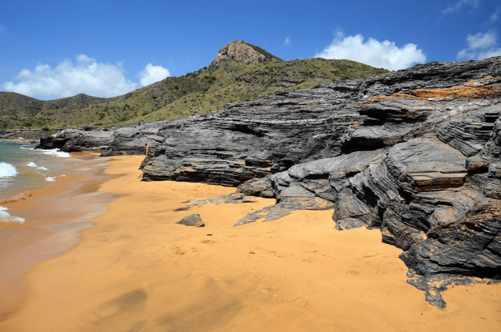 image showing the golden sand and natural rock formations from Calblanque