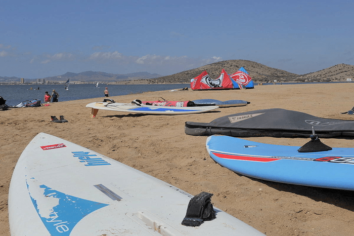 picture of multiple boards in the sand at the beach