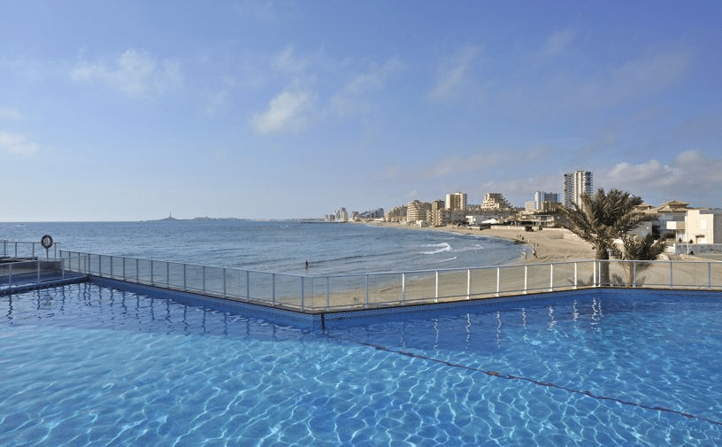 picture taken from inside the hotel's pool showing the beach