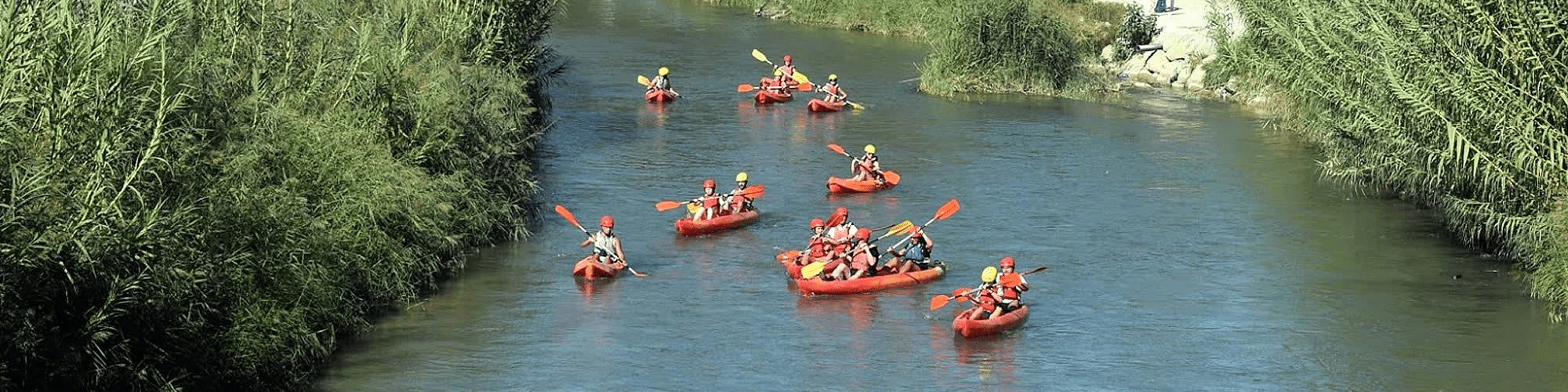 image of a group rafting through a river together