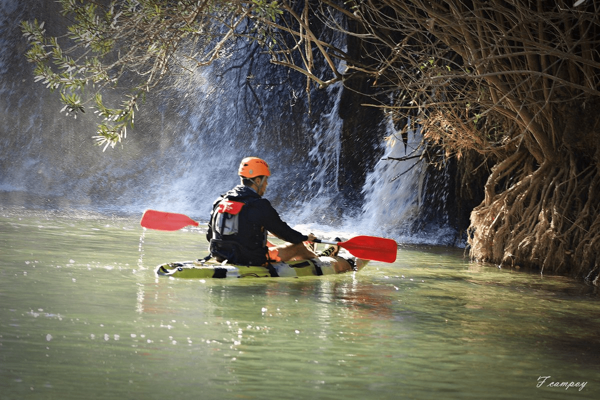 image of a person exploring a river using a kayak