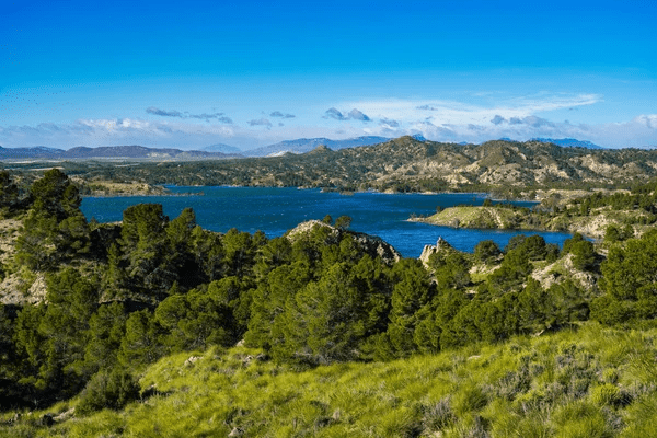 image of calasparra showing the green fields with the river on the background