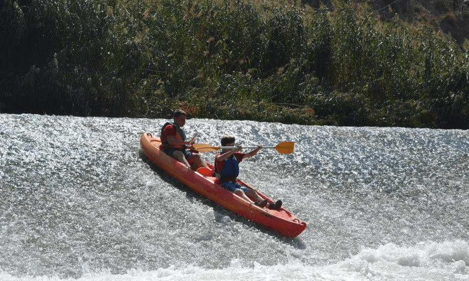 image of two people rafting using a kayak
