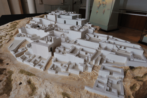 image showing a sculpture of a replica of the city built on a stone