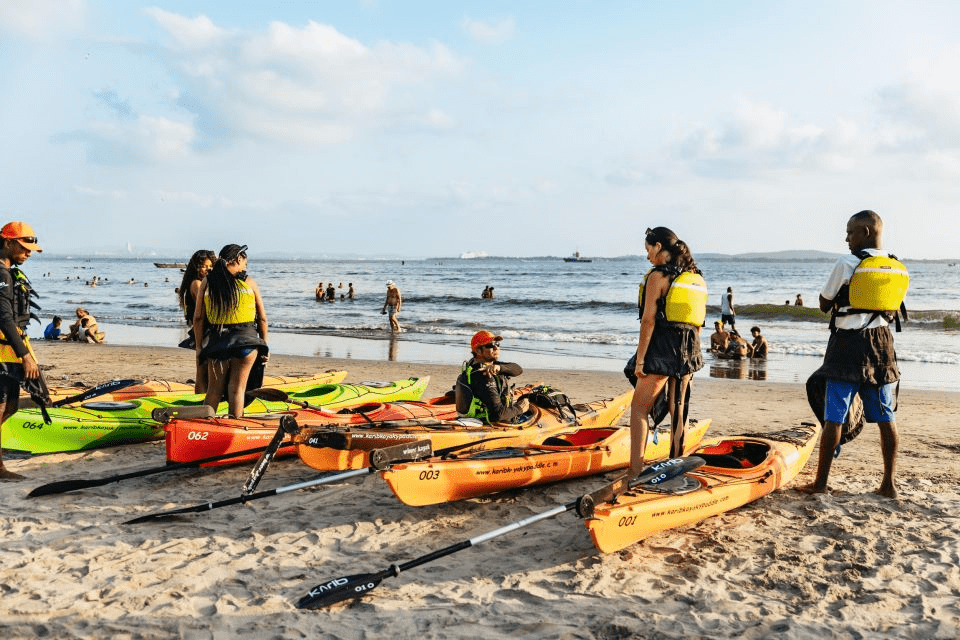 image showing multiple kayaks on the sand in the beach