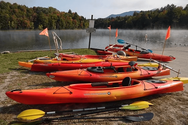 image showing multiple kayaks on the shore