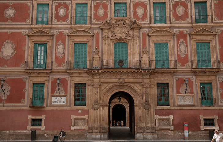 Main facade of Episcopal Palace Of Murcia, with sober volumes and delicate colours. 