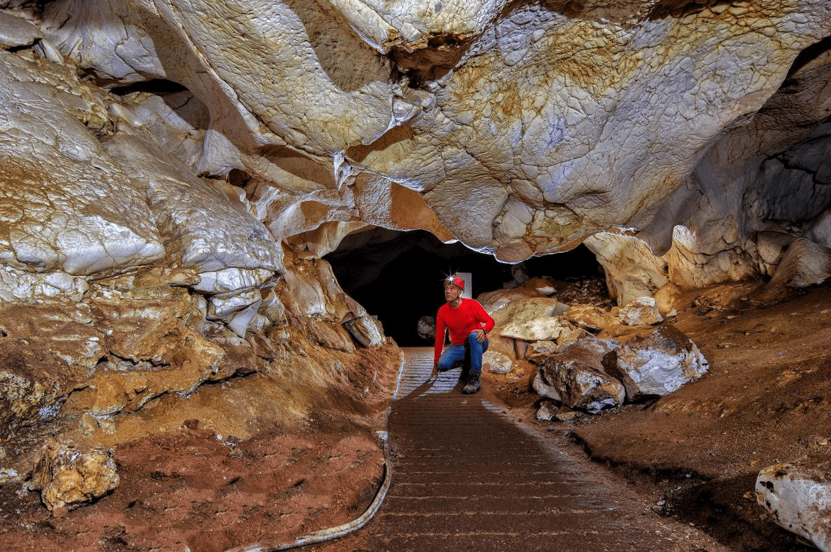 picture of a person inside the cave analyzing the walls