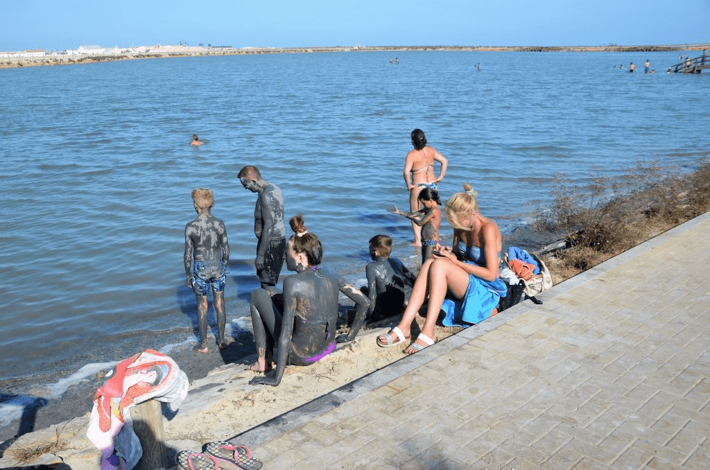 image showing people at the shore of the beach